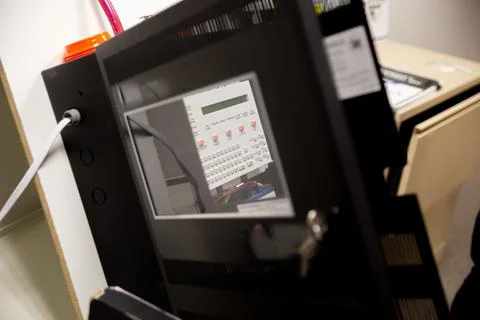 Security guards training how to use fire alarm and mock sprinkler system Stockfoto's