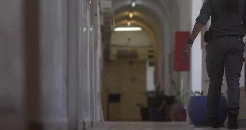Security guards walk in the corridor of the Jerusalem Magistrate's Court Stock Footage 228087291
