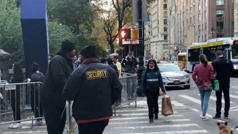 Security guards watch People que in lines for the 50th New York City Marathon Stock Footage 166329331