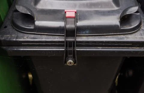 Security Lock on Trash Bin Against Illegal Waste Disposal Stock Photos