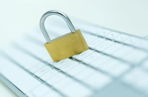 Security lock on white computer keyboard Stock Photos
