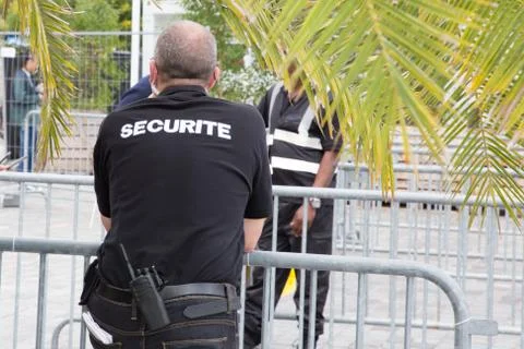 Security man back view duri ng events in street secure entry Stock Photos