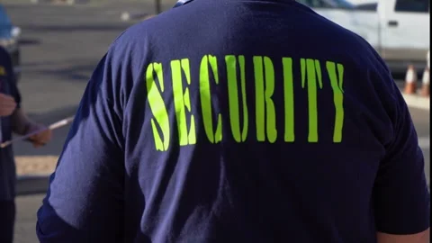 A security man from behind getting a briefing Stock Footage 331312444
