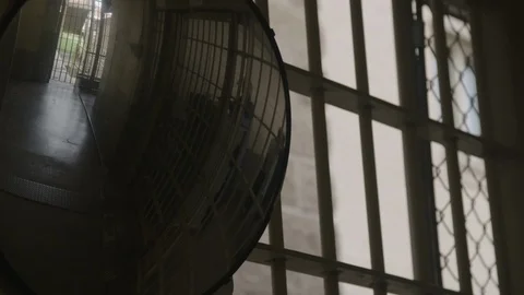 Security mirror of prison gate opening with prisoner and food cart, prison Video stock 91273304