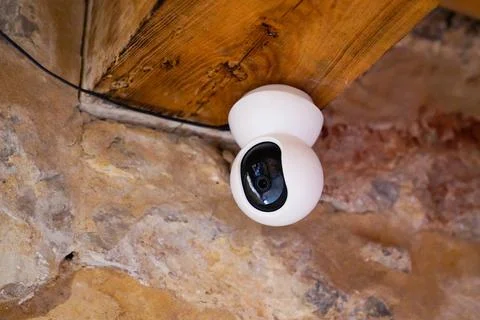 Security modern white round camera cctv on facade wall building Stock Photos