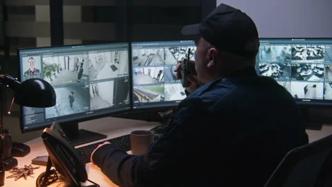 Security officer controls CCTV cameras on computer Stock Footage 236717323