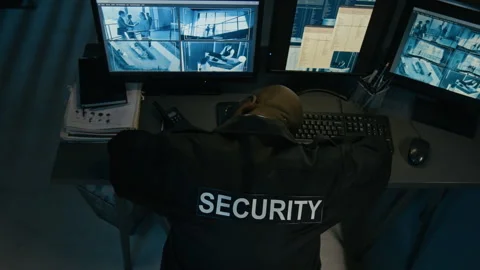 Security Officer Sleeping on Desk in Surveillance Control Room Stock Footage 330608864