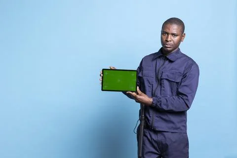 Security officer using a tablet to show an isolated copyspace screen on camera Stock Photos