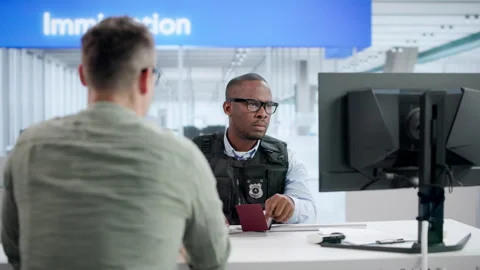 Security Officer Verifies Man’s Passport Using Computer Stock Footage 346321522