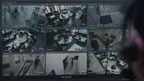 Security operator controls CCTV cameras in office Video stock 236719127
