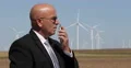 Security Person Using Radio Station in Wind Turbines Area for Communication 4k or 4k+ Resolution