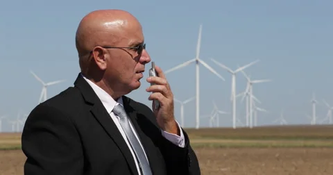 Security Person Using Radio Station in Wind Turbines Area for Communication Stock-Footage 68420198