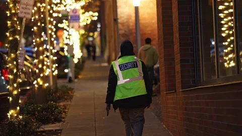 Security personnel walking on a sidewalk Stock Footage 295068467