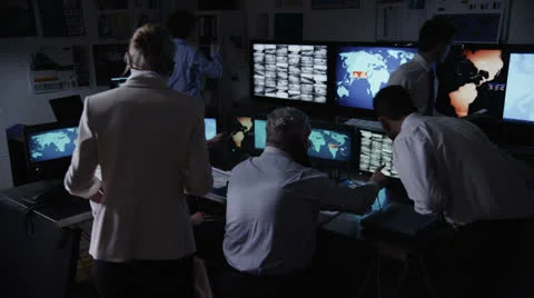 Security personnel watching the screens in a dark system control room Stock Footage