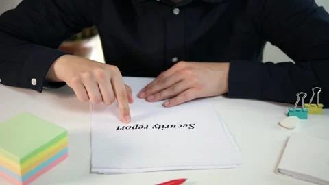 Security report on the desk in front of the businessman. Service audit and Stock Footage 313189871