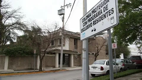 Security sign in an upscale Monterrey residential neighborhood Stock Footage 341231191