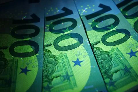 Security signs and elements on euro banknotes glow under ultraviolet light Foto stock