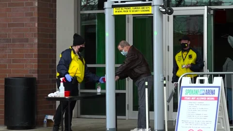 Security Staff Screening Attendees Wearing Masks at Spokane Arena Entrance Stock Footage 345700555