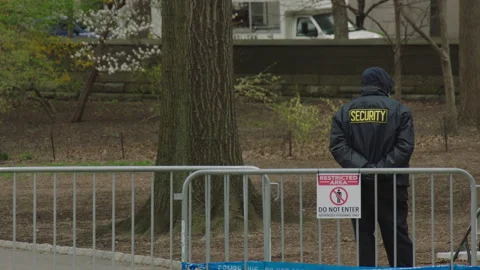 Security stands in front of fence guarding testing site Vídeos de archivo 251194957