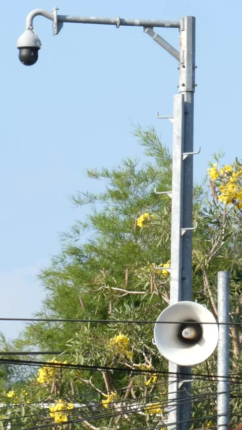 Security surveillance camera and megaphone speaker on a metal pole, public .. Stock Footage 345198255