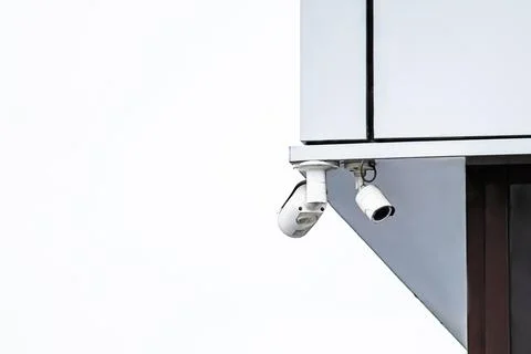 Security surveillance camera on corner of building. Stock Photos