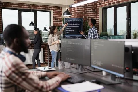 Security system developers analyzing application coding method in order to Stock Photos