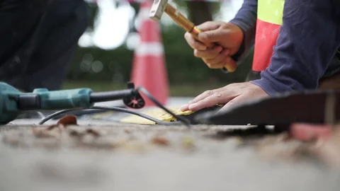 Security team installing safety road speed breaker Stock Footage 119694975