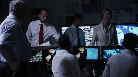 Security team watching the screens in a dark system control room Stock Footage 22820500