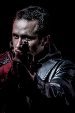 Security, thief, armed man with black leather jacket, dangerous Stock Photos