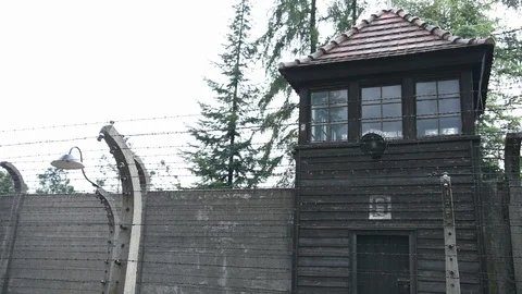Security tower of dark wood and old tiles, which is behind fence of barbed wire Stock Footage 114634560