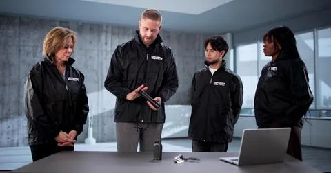 Security Trainer Demonstrates Flashlight Gear To Diverse Security Team Member Stock Photos