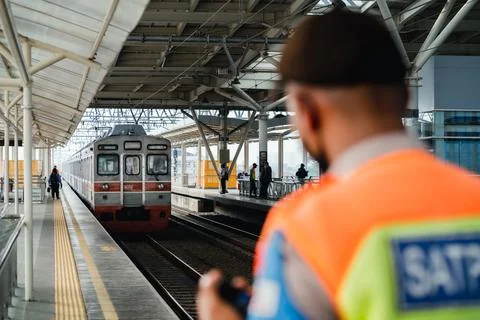 A security was preparing to give information about the arrival of the commuter Stock Photos