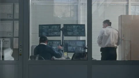 Security worker watch out the window through blinds Stock Footage 237216503