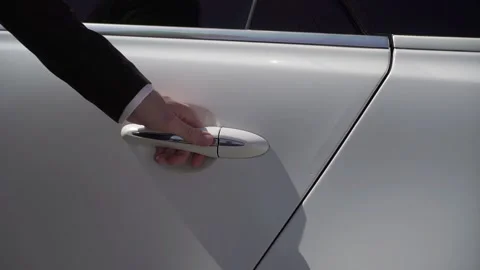 Sedan auto driver opening rear door of white luxury limousine vehicle. Stock Footage 166588982