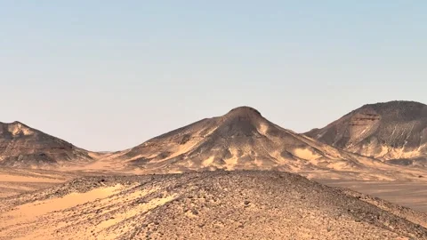 Sede window view from moving vehicle of black rocky hills and sand dunes in 動画素材 340867683