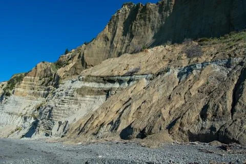 Sedimentary Cliffside Under Clear Blue Sky Stock Photos