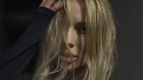 Seductive blonde woman looking at the camera in slow motion Stock Footage 73023251