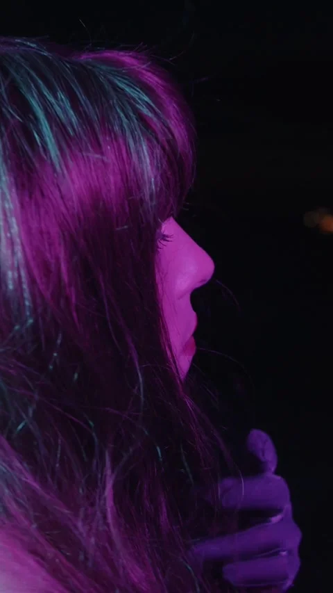 Seductive drag queen turning towards camera at night Stock Footage 329673638
