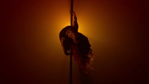 Seductive girl performing sexy dance on club pylon. Woman practicing poledance Stock Footage