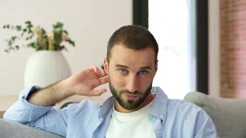 Seductive handsome man winking and smiling at the camera Stock Footage 335588450