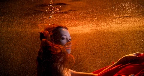 Seductive lady with red fabric dives in water slow motion Stock Footage 121704767
