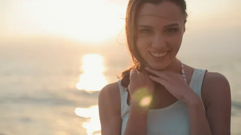 Seductive model with a beautiful smile standing back to the camera near the sea Stock Footage 53755713