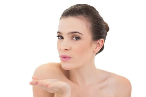 Seductive natural brown haired model blowing a kiss to the camera Stock Photos