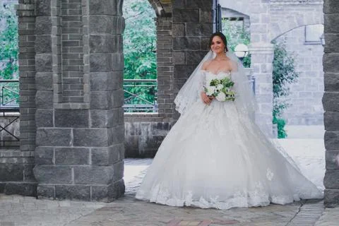 Seductive young bride posing on the territory of country hotel Stock Photos