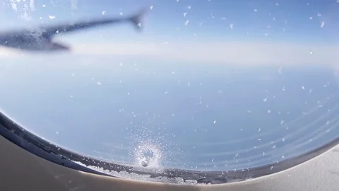 See through the airplane window with ice flying above the clouds sunny day 4k Stock-Footage 75186558