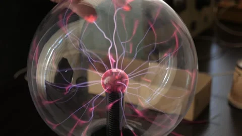 See-through sphere circling to demonstrate the electromagnetic field device Stock Footage 153785595