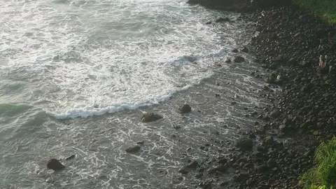 See the waves on the beach from the cliff Stock Footage 294976058
