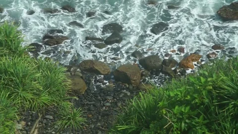 See the waves on the beach from the cliff Stock Footage 295472396