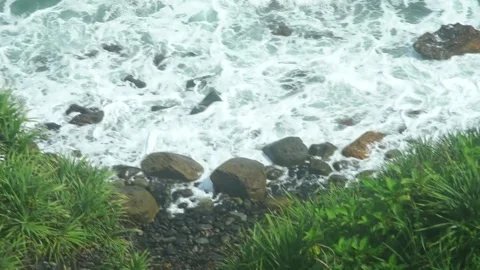 See the waves on the beach from the cliff Stock Footage 295472397