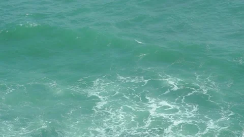 See the waves on the beach from the cliff Stock Footage 295472479